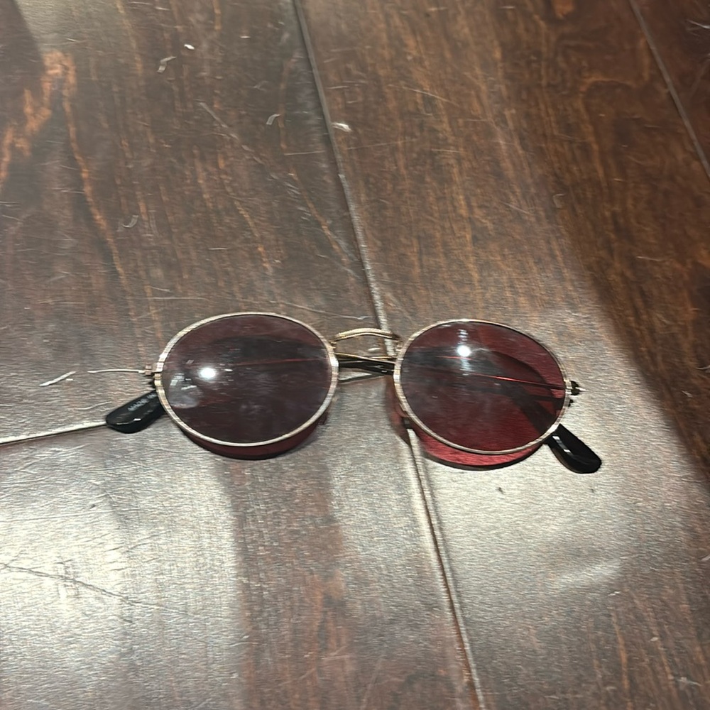 rose gold glasses with red lenses.